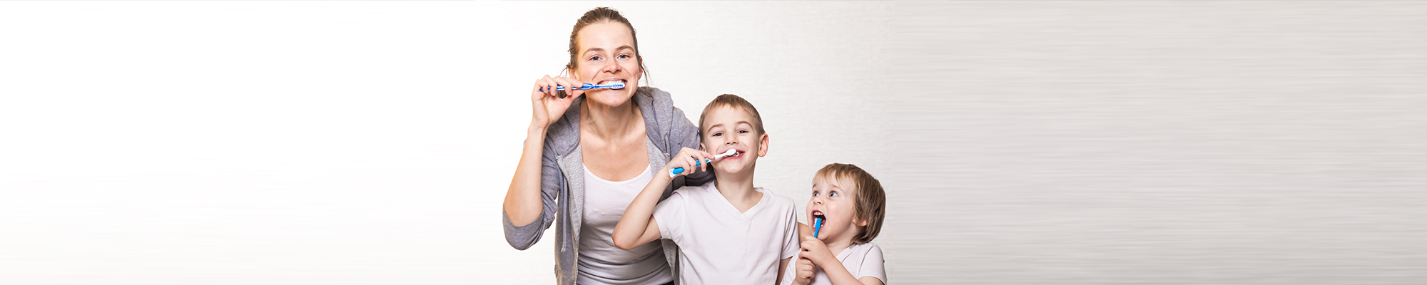 Family brushing teeth together